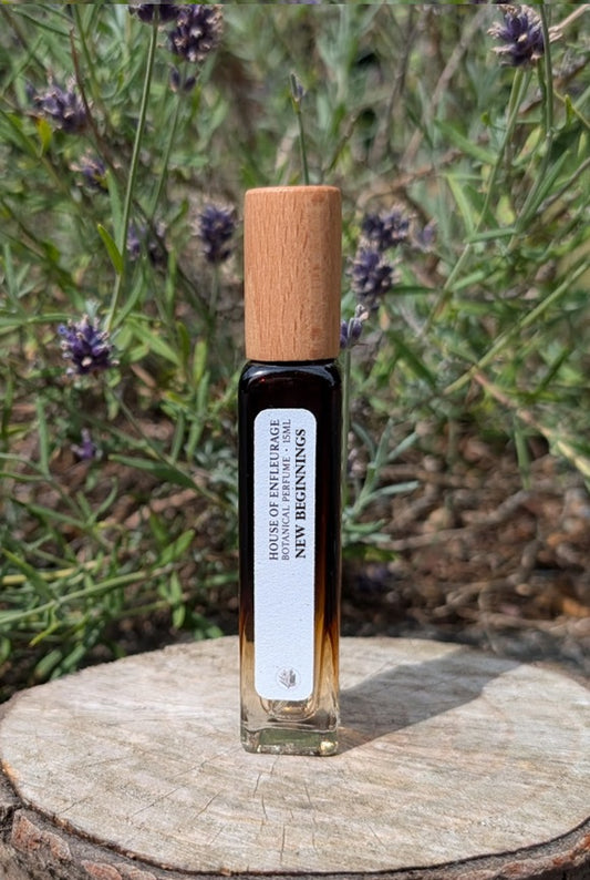 Botanical spray perfume with wooden cap on a wooden surface with lavender plants in the background